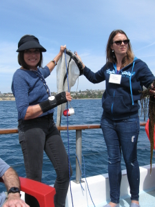 Board member Patricia Twitty helps to bring in a plankton catch.